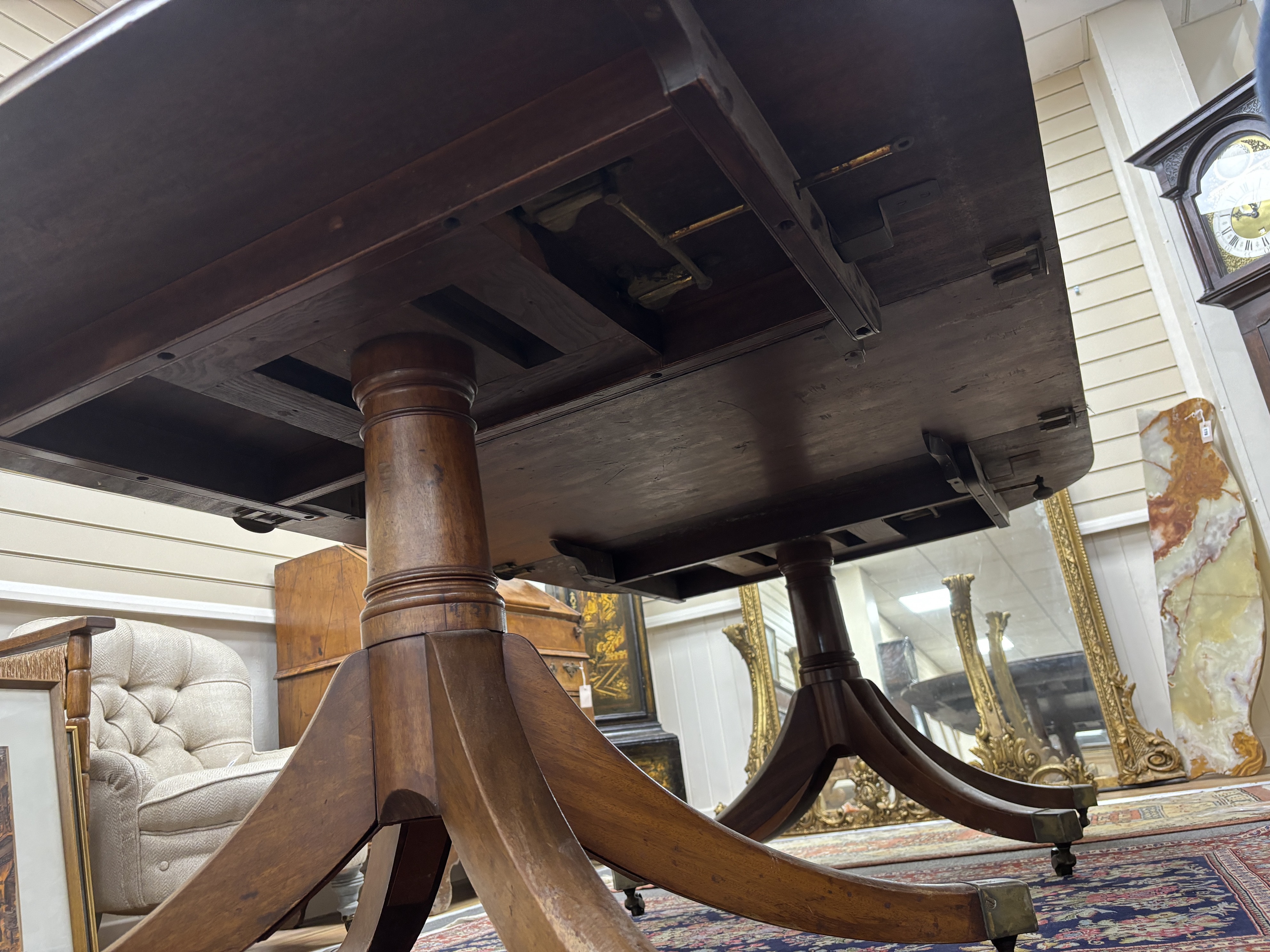 A Regency mahogany twin pillar extending dining table, 208cm extended, one spare leaf (with one other leaf but lacks extension bars, depth 116cm, height 71cm